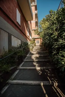 a walkway in front of a building next to a building at Vatican Suite 