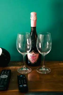 a bottle of wine and two wine glasses on a table at Vatican Suite 