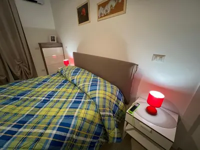 a bedroom with a bed with two red candles on it at Casa Caffarella in Rome
