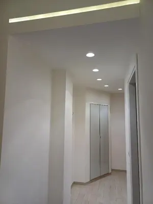 a hallway with white walls and a ceiling with a door at Casa Caffarella in Rome