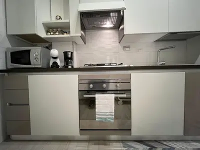 a kitchen with a stove and a microwave at Casa Caffarella in Rome
