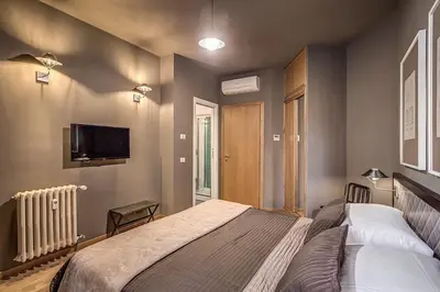 a bedroom with a bed and a flat screen tv at Interno5 in Rome