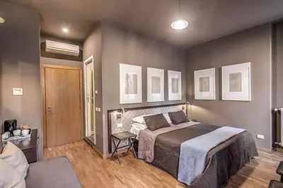 a bedroom with a bed and a chair in it at Interno5 in Rome