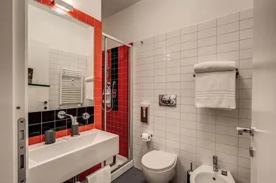 a bathroom with a white sink and a toilet at Interno5 in Rome