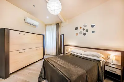 a bedroom with a bed and a large wooden closet at Interno5 in Rome