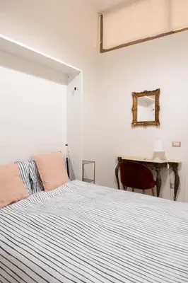 a white bedroom with a bed and a desk at Vita Nova House 3 camere 3 bagni perfetta per famiglie e gruppi a due passi da Termini in Rome