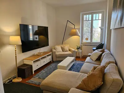 a living room with a couch and a flat screen tv at Saint Peters Place 2BR near Vatican in Rome
