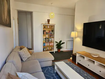 a living room with a couch and a flat screen tv at Saint Peters Place 2BR near Vatican in Rome