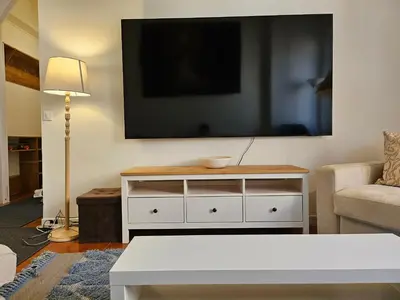 a living room with a white dresser and a tv at Saint Peters Place 2BR near Vatican in Rome