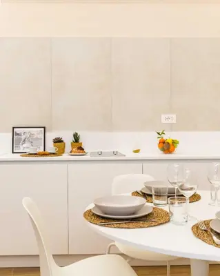 a white dining room with a table and chairs at Monti Nonna Francesca - ZENO 49 in Rome