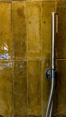 a hairbrush hanging on a tiled wall at Monti Nonna Francesca - ZENO 49 in Rome
