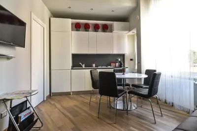 a kitchen and dining room with a table and chairs at Lata Luxury Apartment in Rome