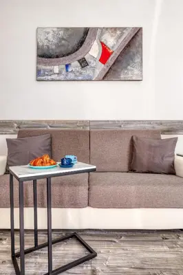 a table with a plate of food on a couch at Casa Enriqueta in Rome