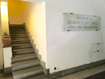 a stairway in a building with a sign on it at Casa Enriqueta in Rome