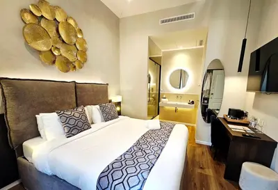 a bedroom with a large bed and a bathroom at STOA ROME Boutique Suites in Rome