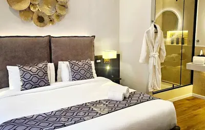 a bedroom with a large bed with purple and white pillows at STOA ROME Boutique Suites in Rome