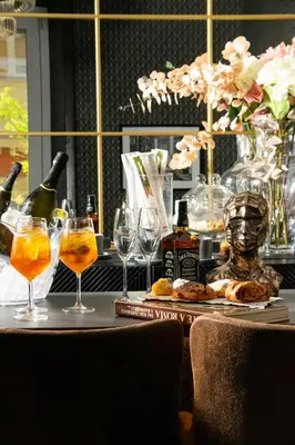 a table with glasses and bottles of wine and food at STOA ROME Boutique Suites in Rome
