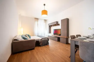 a living room with a couch and a dining room at Via Niso Apartment in Rome