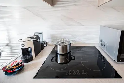 a kitchen with a coffee maker on a stove at Via Niso Apartment in Rome