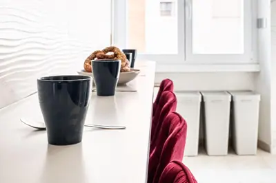 a table with two cups and a plate of food at Via Niso Apartment in Rome