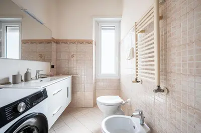 a bathroom with a toilet and a sink at Via Niso Apartment in Rome