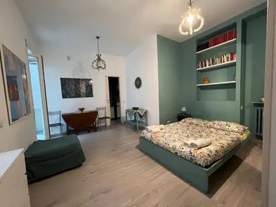 a bedroom with a bed with a green wall at Cozy Studio near Vaticano in Rome