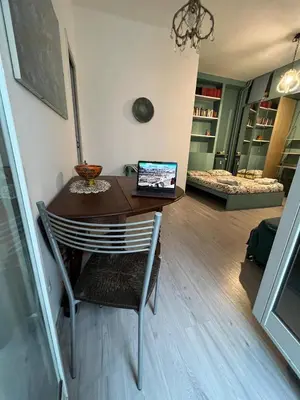 a dining room table with a laptop computer on it at Cozy Studio near Vaticano in Rome