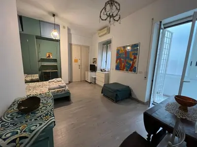 a large living room with a couch and a table at Cozy Studio near Vaticano in Rome