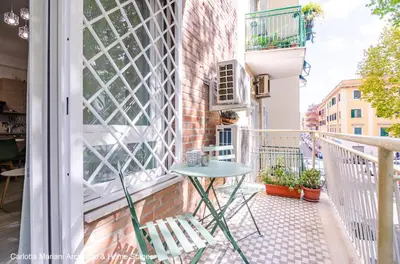 a small table on the balcony of a building at Acquedotti House in Rome