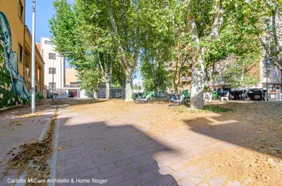 a street with trees and a brick sidewalk at Acquedotti House in Rome