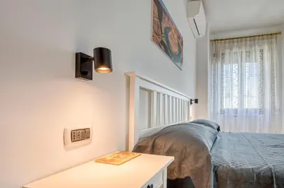 a bedroom with a bed and a table at Dimora Savorelli, ampio appartamento zona Vaticano in Rome