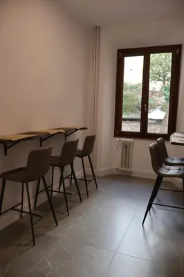 a room with tables and chairs and a window at COLOSS IMPERIAL SUITE Guest House in Rome