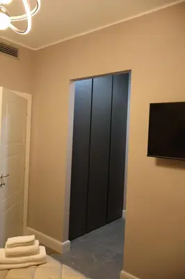 a bathroom with a black closet with towels on the floor at COLOSS IMPERIAL SUITE Guest House in Rome