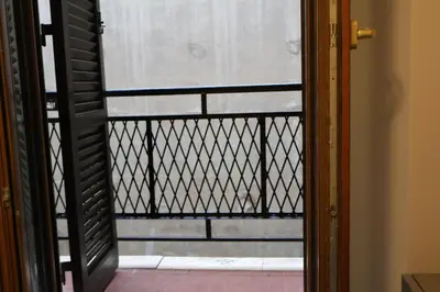 an open door to a balcony with a fence at COLOSS IMPERIAL SUITE Guest House in Rome