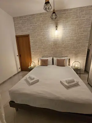 a bedroom with a large bed with two towels on it at Domus Imperiali in Rome