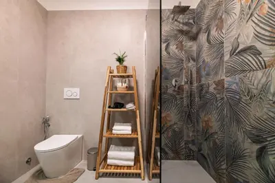 a bathroom with a mirror and a potted plant at Luxury Jacuzzi Suites Rome - You Rhome in Rome