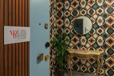 a hallway with a wall with a moroccan inspired wallpaper at Luxury Jacuzzi Suites Rome - You Rhome in Rome
