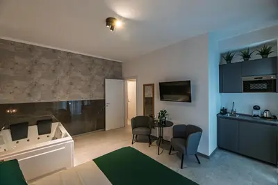 a room with a bed and a table and chairs at Luxury Jacuzzi Suites Rome - You Rhome in Rome