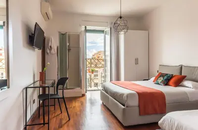 a bedroom with a bed and a desk and a window at Torripa Group - Prati in Rome