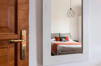 a bedroom with a bed and a door with a mirror at Torripa Group - Prati in Rome