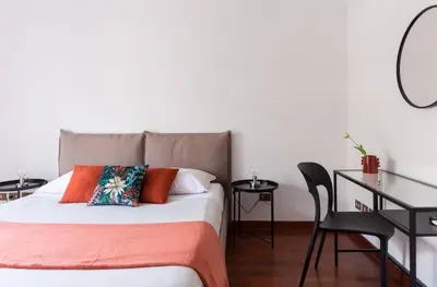 a bedroom with a bed and a table and chairs at Torripa Group - Prati in Rome