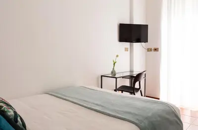 a bedroom with a bed and a table and a desk at Torripa Group - Prati in Rome