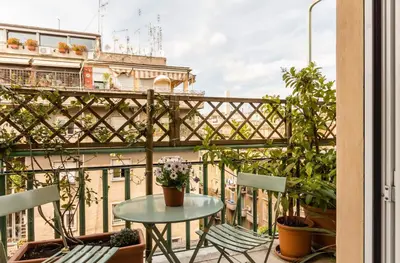 a patio with a table and chairs on a balcony at Torripa Group - Prati in Rome