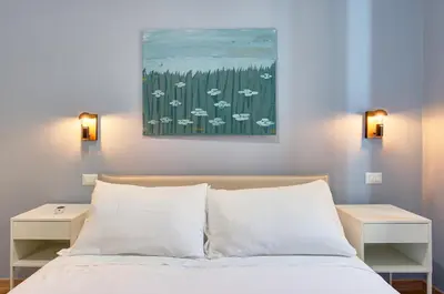 a bedroom with a bed and a painting on the wall at Vatican Lante Apartment in Rome