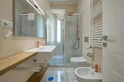a bathroom with two sinks and a shower and a toilet at Vatican Lante Apartment in Rome