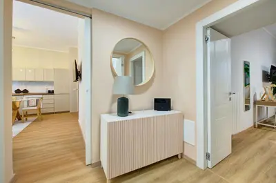 a room with a mirror and a table with a lamp at Vatican Lante Apartment in Rome