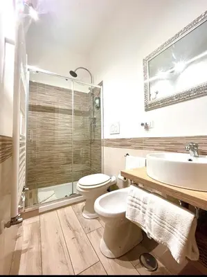 a bathroom with a toilet and a sink and a shower at Suite Old Testaccio 2 in Rome
