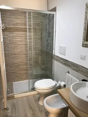 a bathroom with a shower and a toilet and a sink at Suite Old Testaccio 2 in Rome