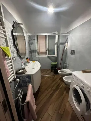 a bathroom with a sink and a shower and a toilet at Nathan House, Tuscolana in Rome