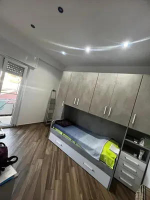 a bed in a room with wooden cabinets at Nathan House, Tuscolana in Rome